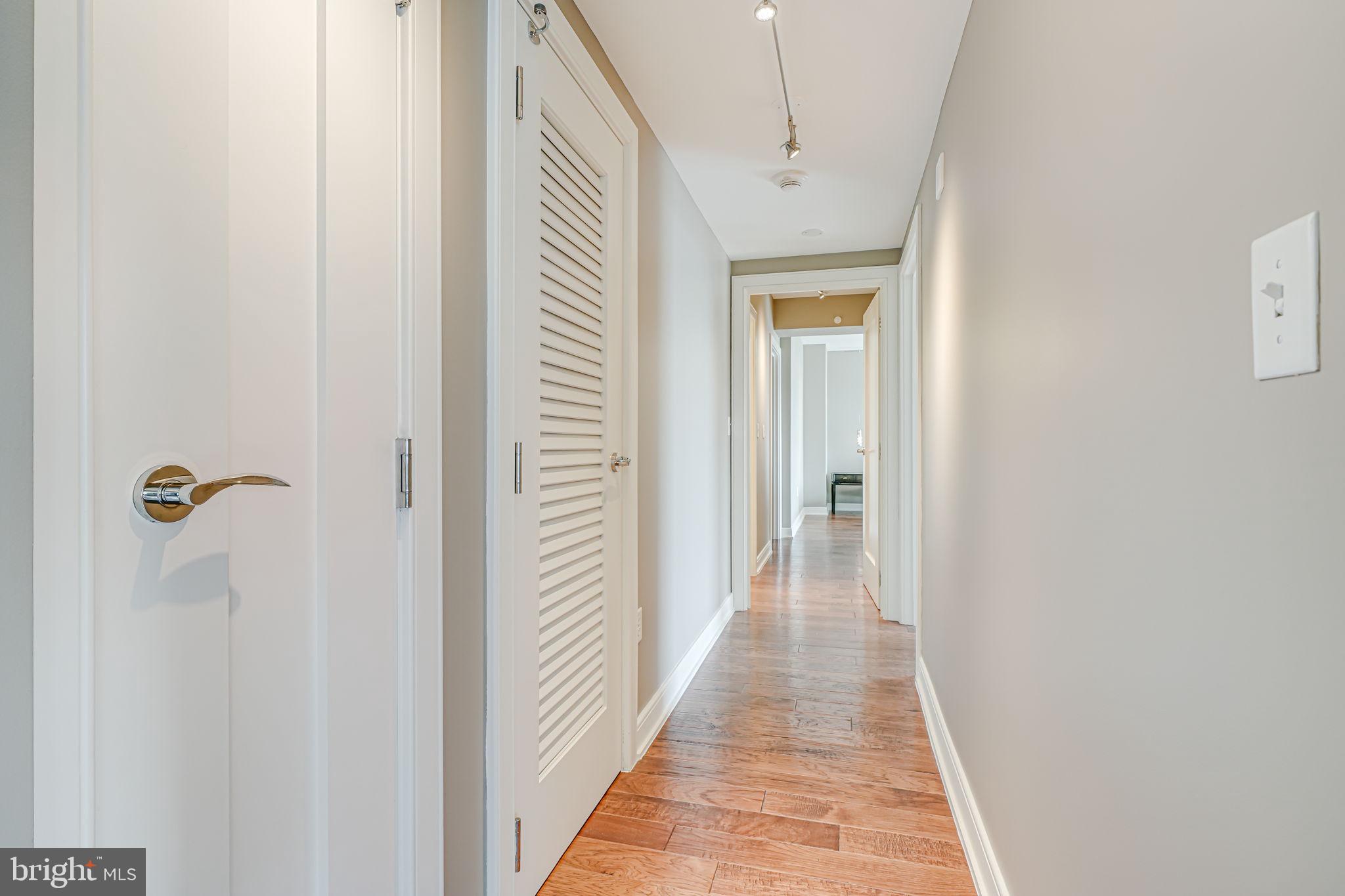 1111 19th Street North, Unit 2703 Arlington, VA 22209 - Photo 27 of 52 a view of a hallway with wooden floor and staircase