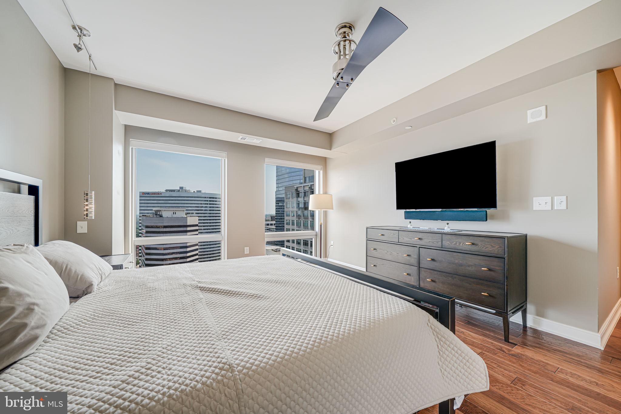 1111 19th Street North, Unit 2703 Arlington, VA 22209 - Photo 31 of 52 a bedroom with a bed and a flat screen tv