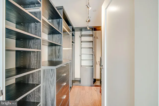 a spacious bathroom with a granite countertop sink a mirror and a shower