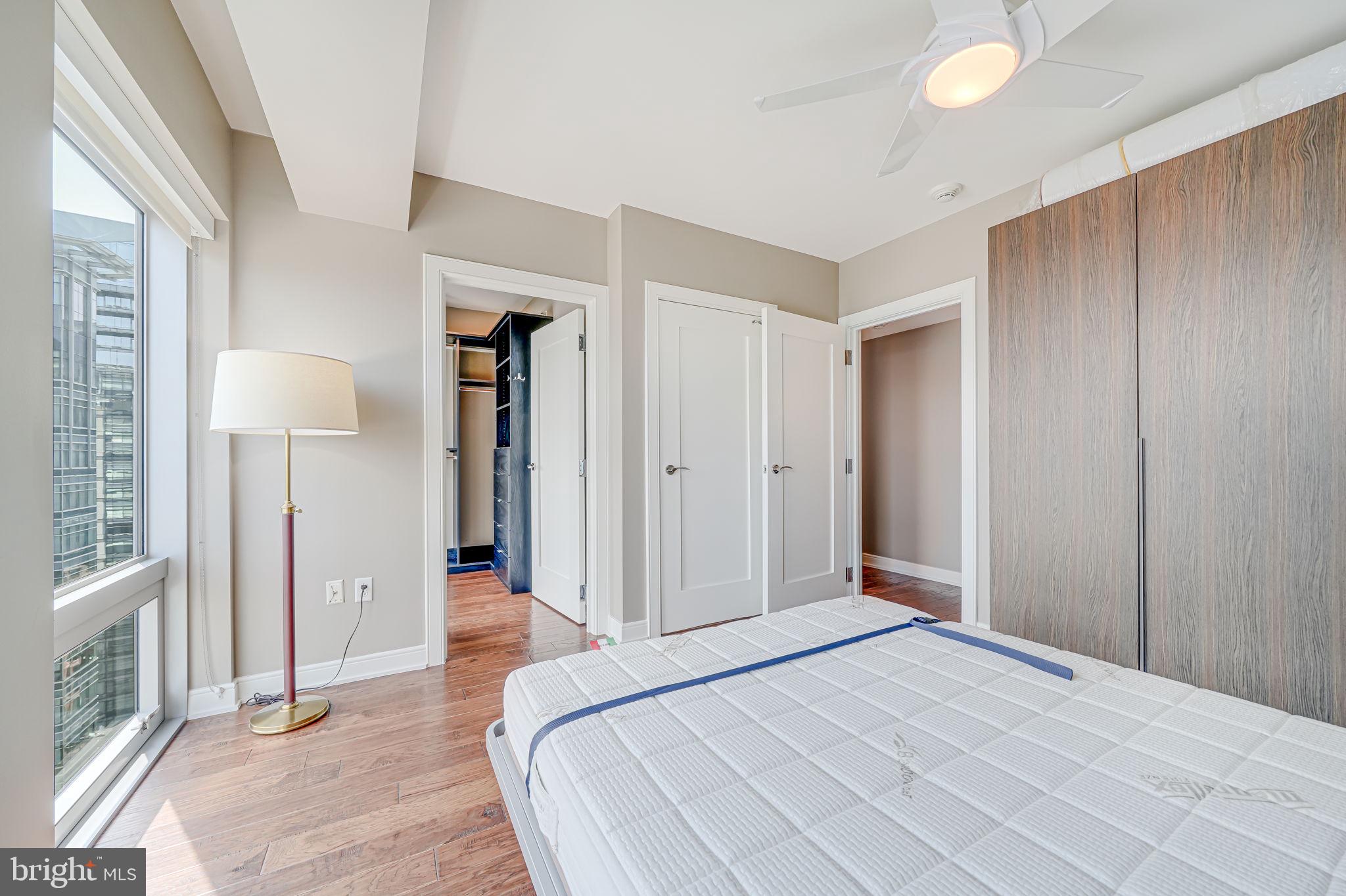 1111 19th Street North, Unit 2703 Arlington, VA 22209 - Photo 41 of 52 a bedroom with a bed and a mirror