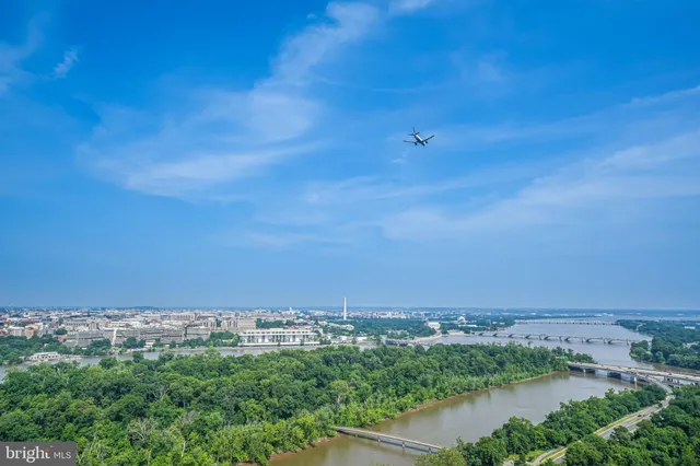 an aerial view of a city and lake view