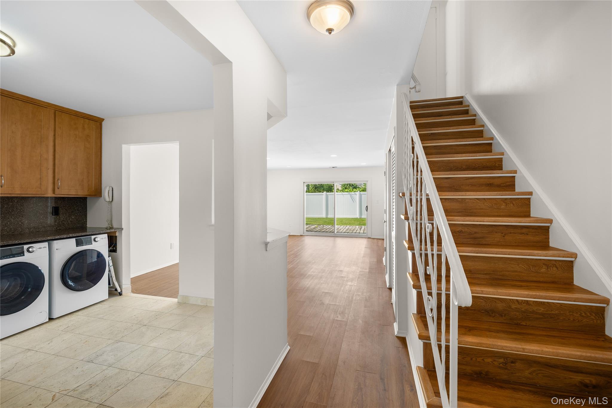 650 Newbridge Road, Unit 15 East Meadow, NY 11554 - Photo 3 of 20 a view of a livingroom with wooden floor and stairs