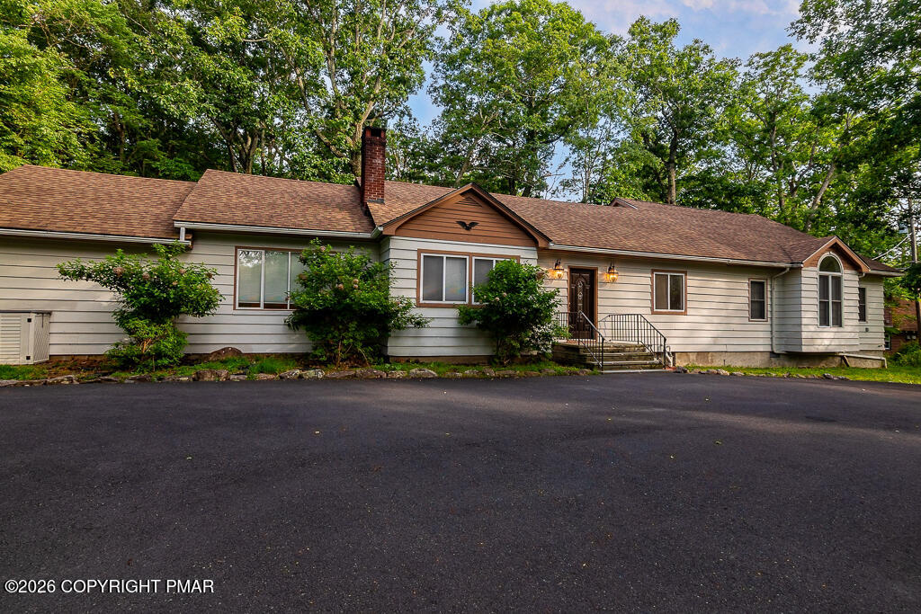 755 White Oak Road Cresco, PA 18326 - Photo 42 of 50 a front view of a house with a yard and garage