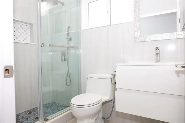 a bathroom with a toilet sink and shower
