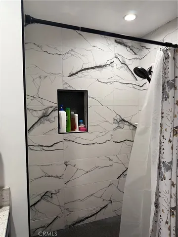 a bathroom with a bathtub and a shower