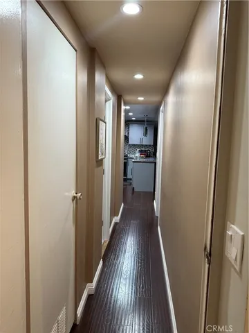a view of hallway with wooden floor