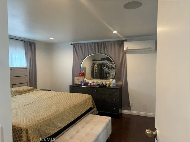 a bedroom with a bed and a dresser