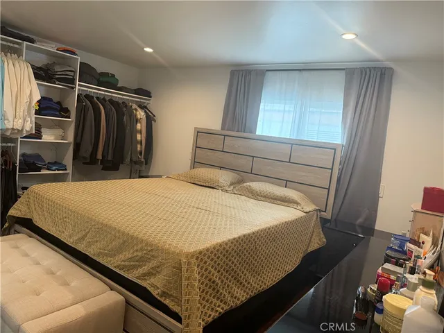 a bed sitting in a bedroom and balcony