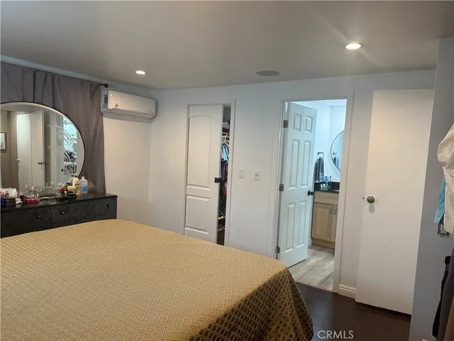 a bedroom with a bed and a mirror
