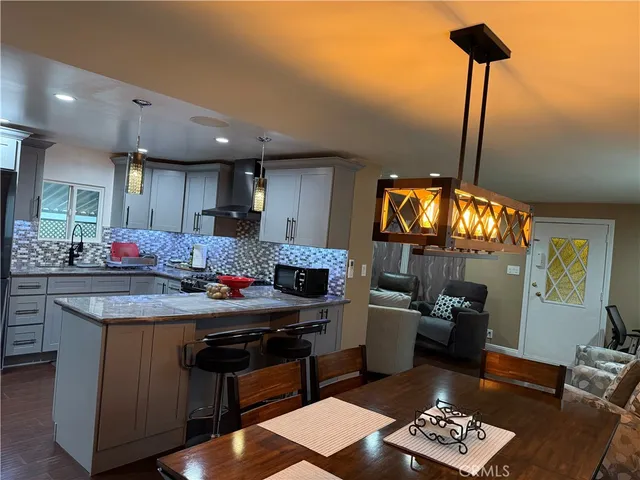 a kitchen with granite countertop a stove and a wooden floor