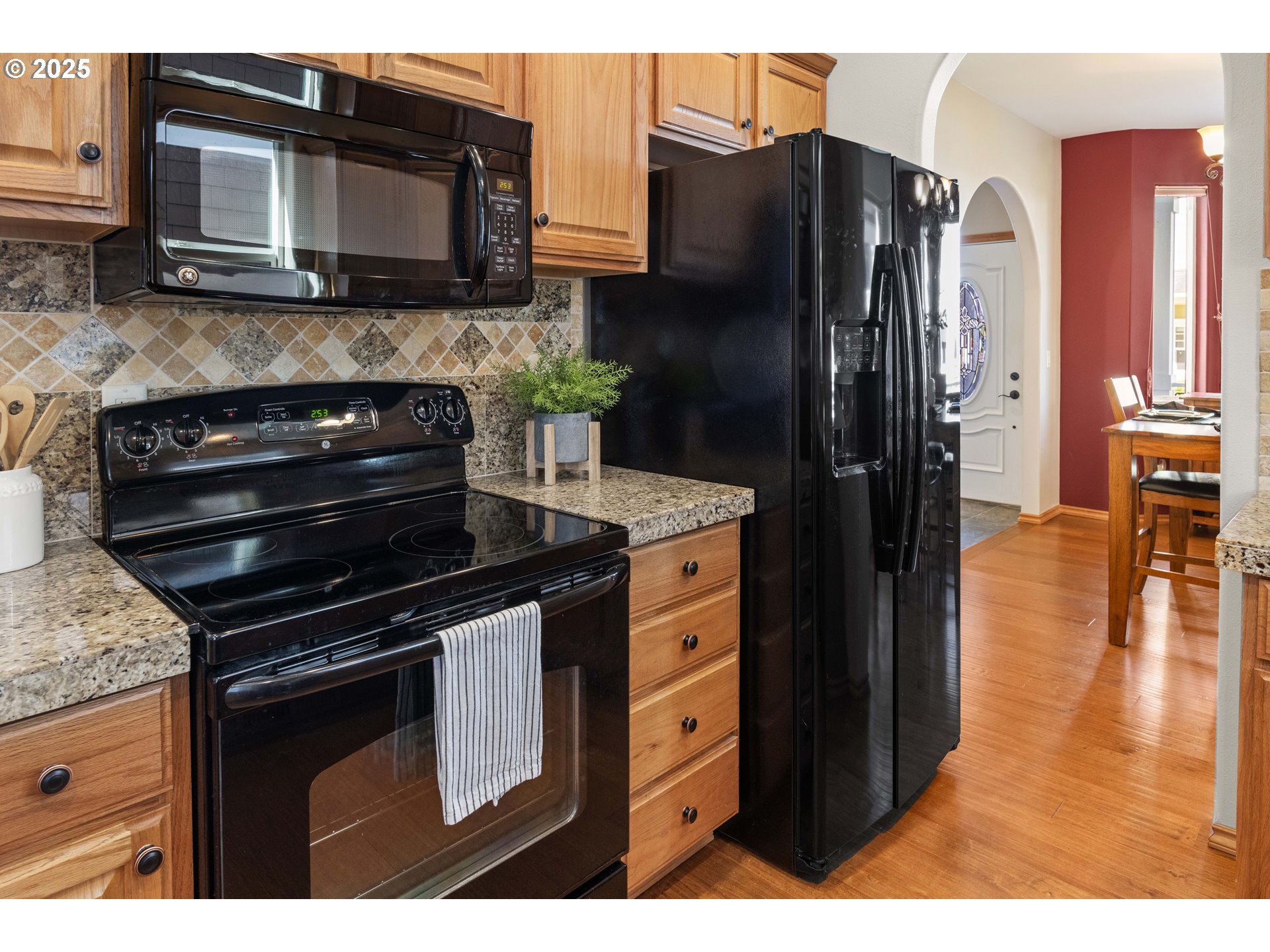 260 Round House Road Astoria, OR 97103 - Photo 14 of 37 a kitchen with granite countertop a refrigerator stove and microwave