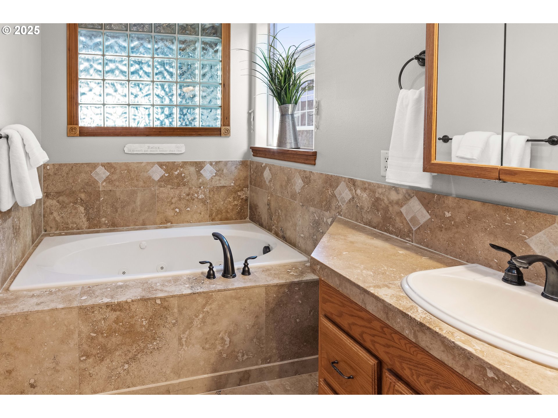 260 Round House Road Astoria, OR 97103 - Photo 21 of 37 a bathroom with a tub a sink and a window
