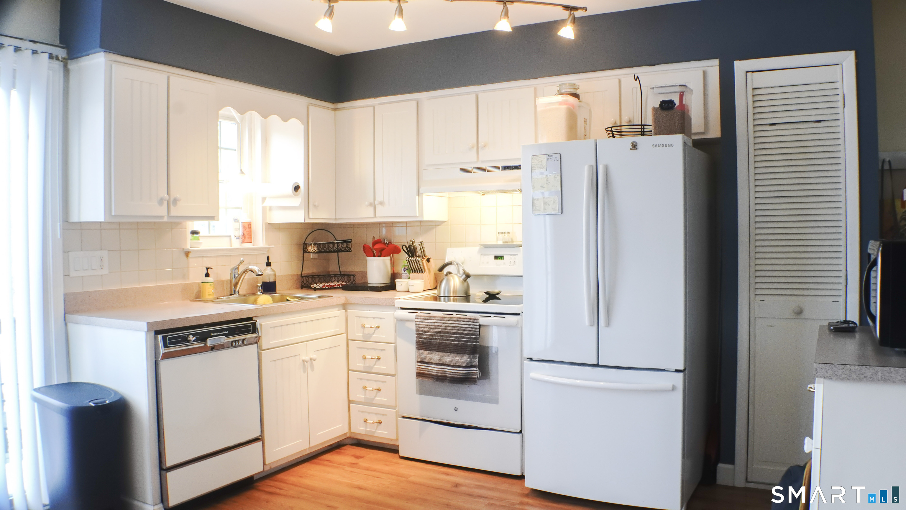 14 Scuppo Road, Unit F3 Danbury, CT 06811 - Photo 5 of 10 a kitchen with a refrigerator a sink and white cabinets