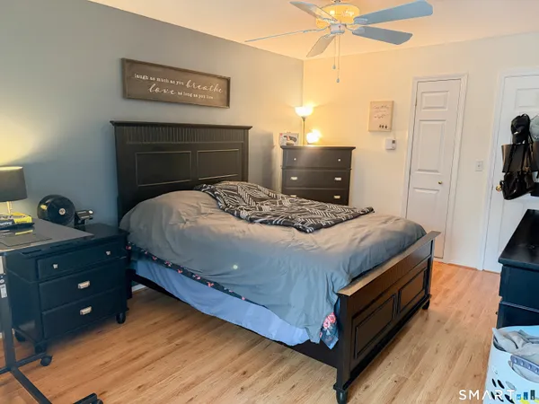 a bed sitting in a bedroom next to a window with a lamp