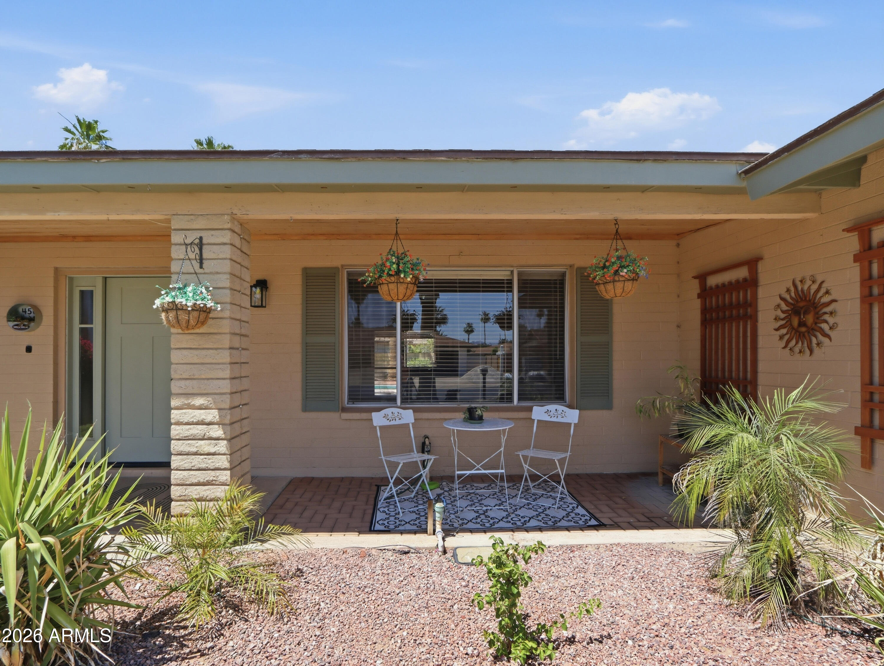 450 Cascada Road Litchfield Park, AZ 85340 - Photo 4 of 40 a view of a patio with table and chairs and potted plants