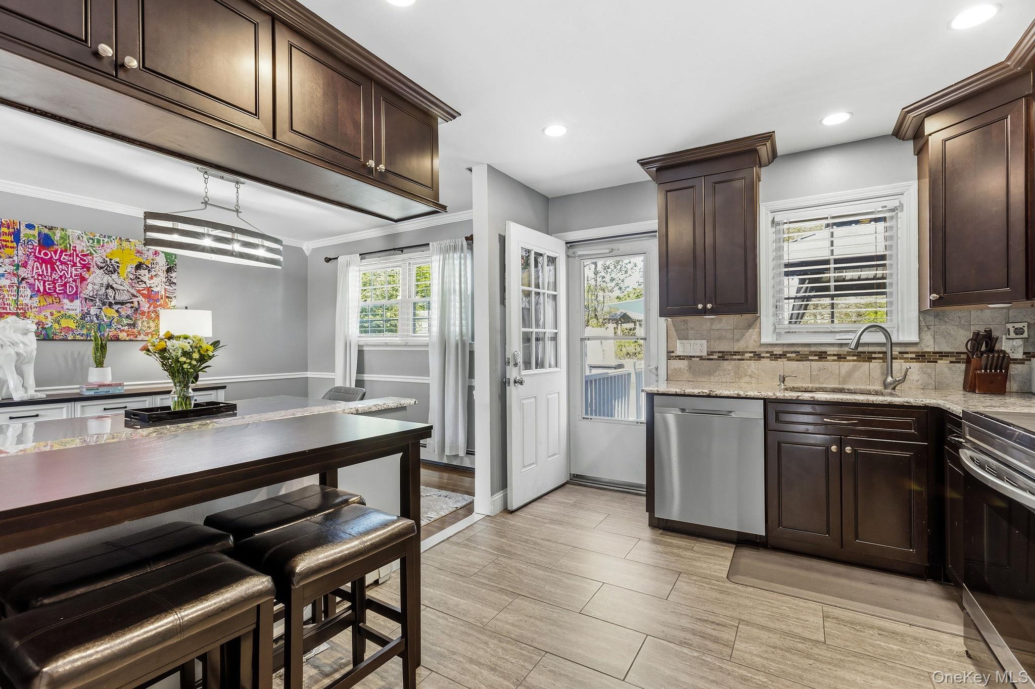 56 Tanager Road Mahopac, NY 10541 - Photo 11 of 30 a kitchen with stainless steel appliances kitchen island granite countertop a sink cabinets and wooden floor