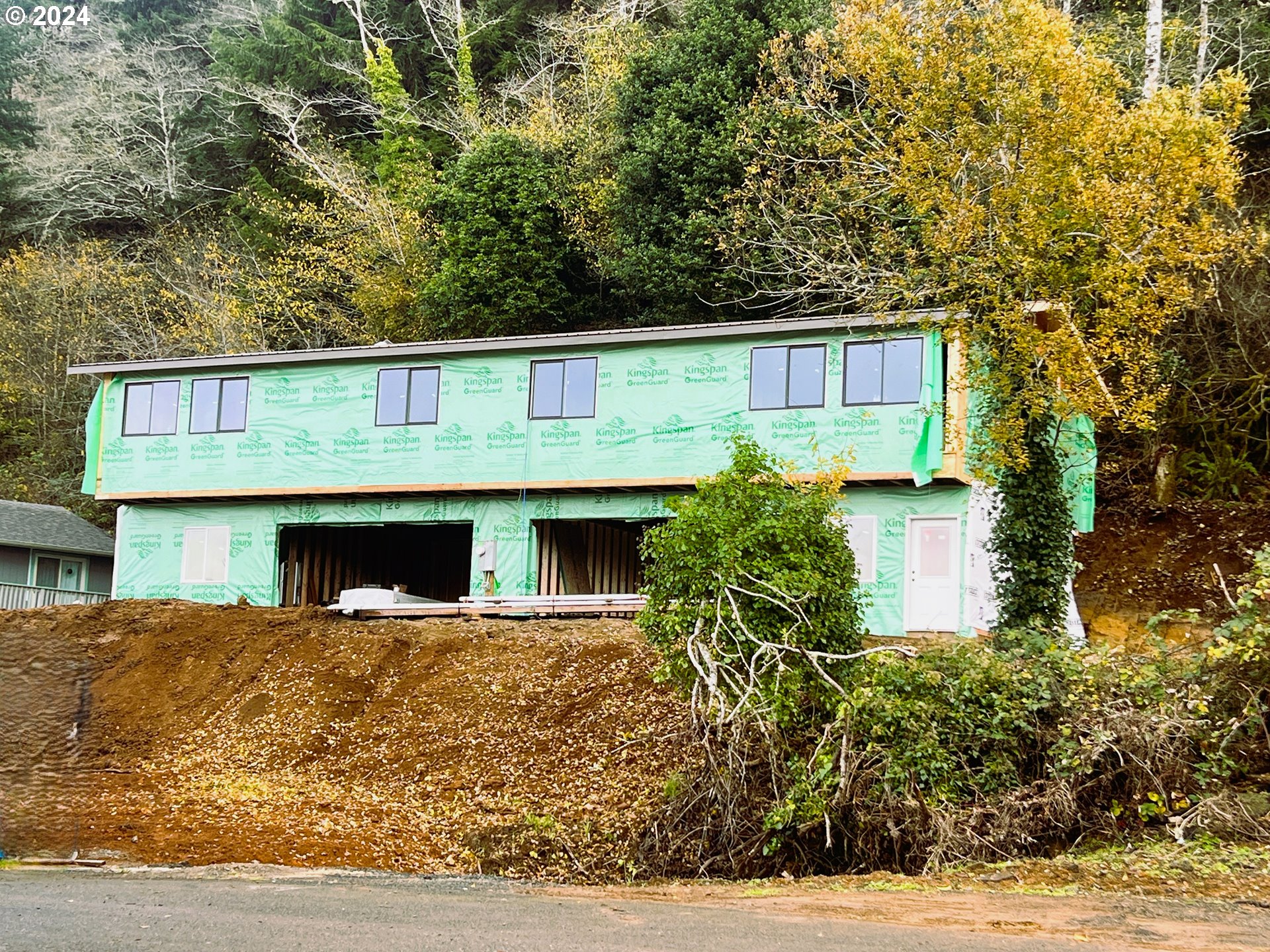 680-682 Elm Avenue Reedsport, OR 97467 - Photo 2 of 36 a front view of a house with plants