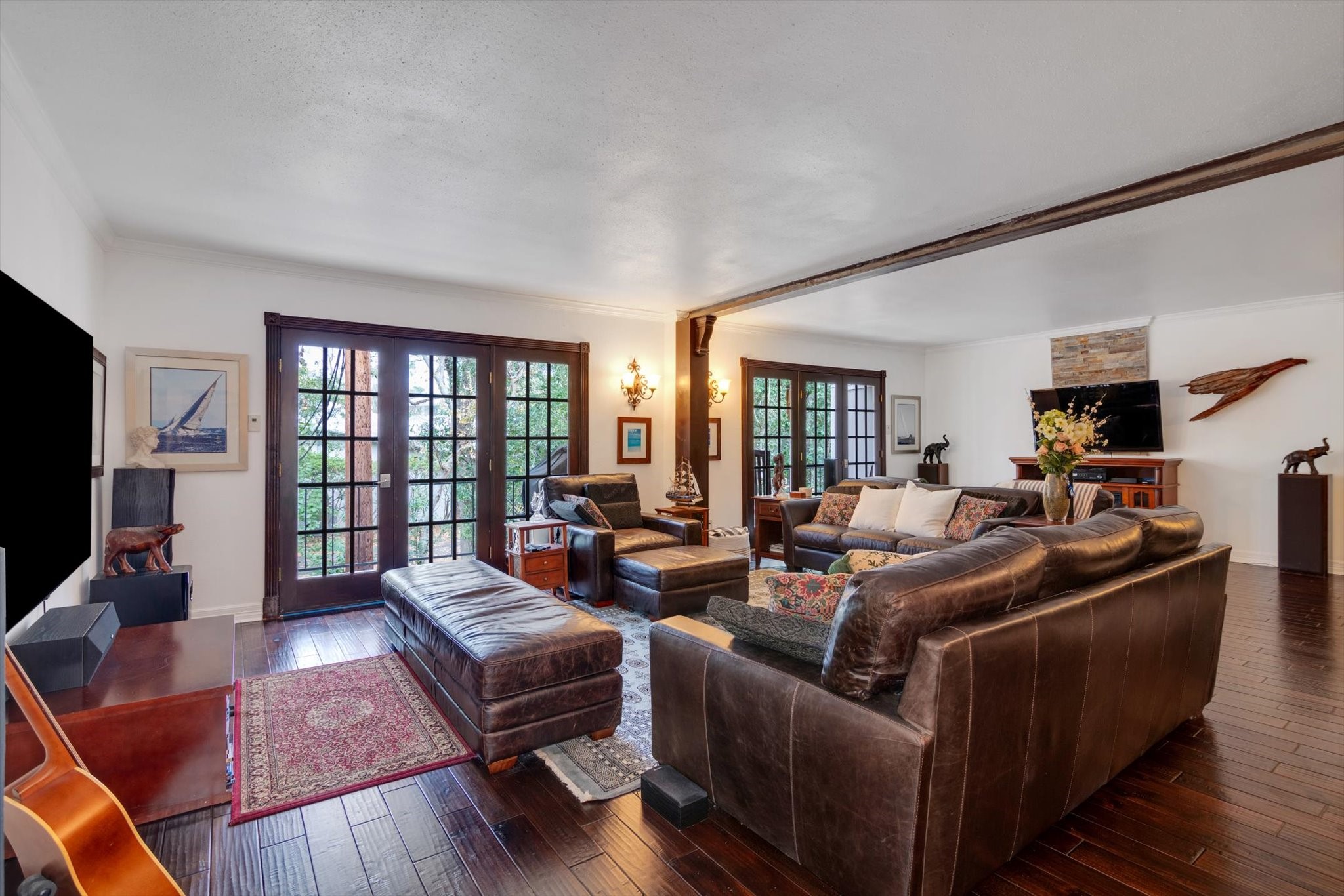 a living room with furniture wooden floor and a large window