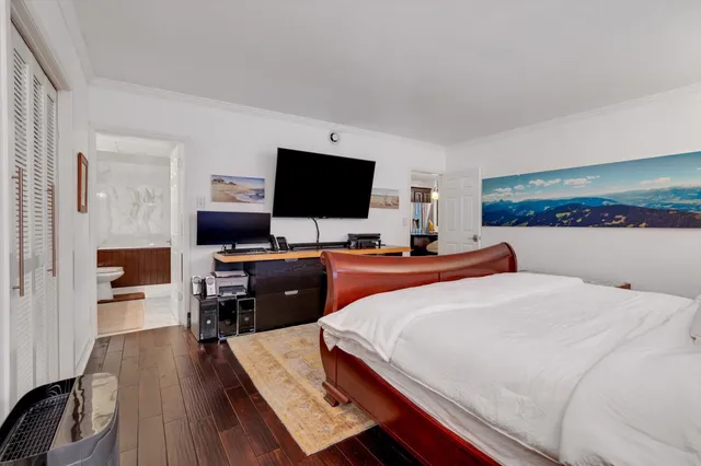 a bedroom with a bed a lamp and a dresser