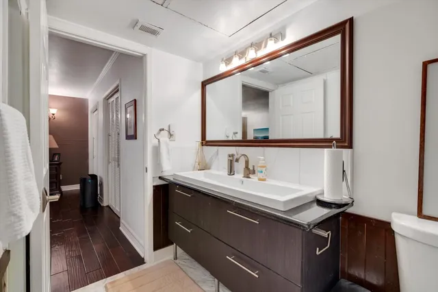a bathroom with a sink a toilet and a mirror