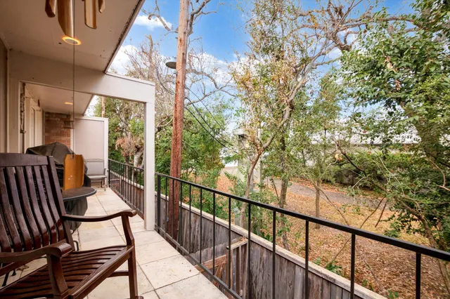 a view of a white house with a yard and plants