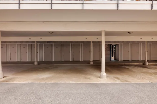 a view of a brick house with a yard and potted plants