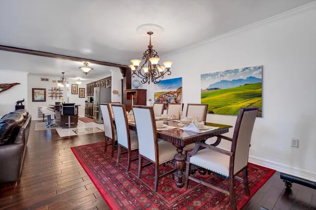 a view of a dining room with furniture wooden floor and chandelier