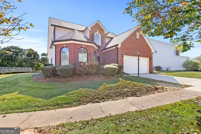 a front view of a house with a yard