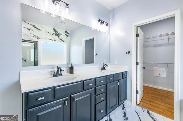 a bathroom with a double vanity sink mirror and double