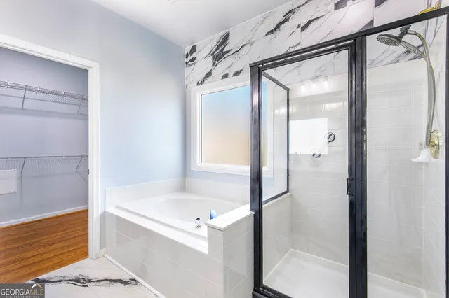 a bathroom with a bathtub and a shower