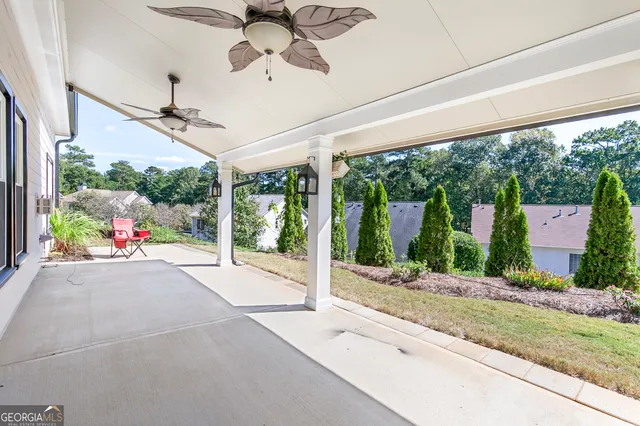 a very nice looking yard with a large window and chandelier