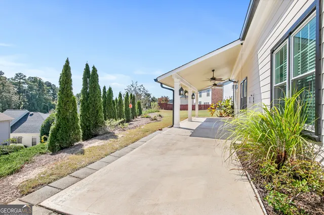 a view of a patio with a table and chairs under an umbrella