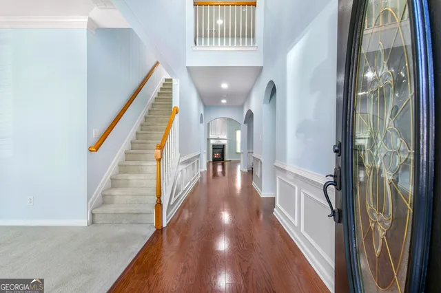 a view of entryway and hall with wooden floor