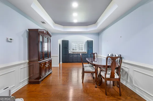 a view of a dining room with furniture window and wooden floor