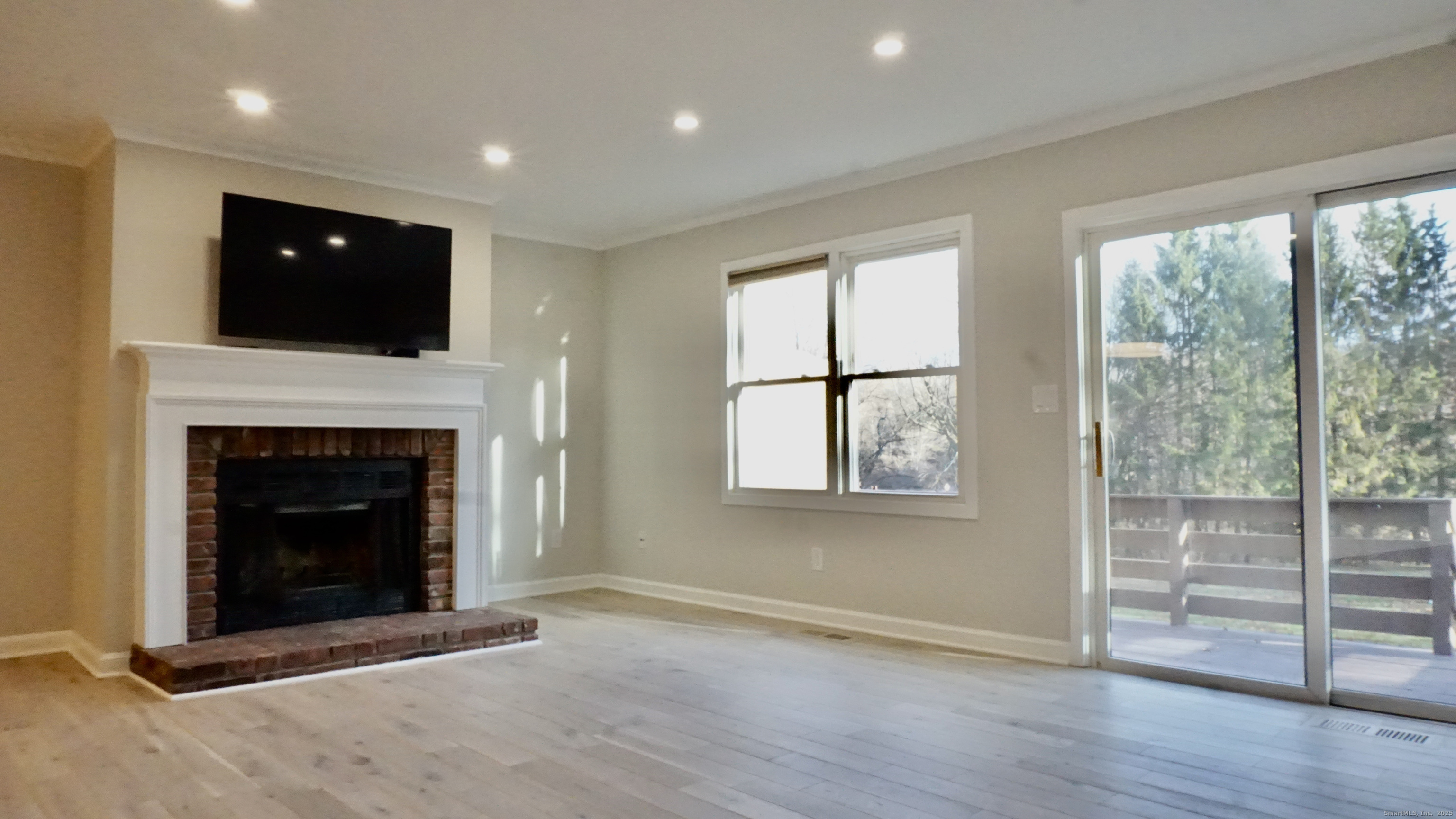 a living room with a fireplace and a floor to ceiling window