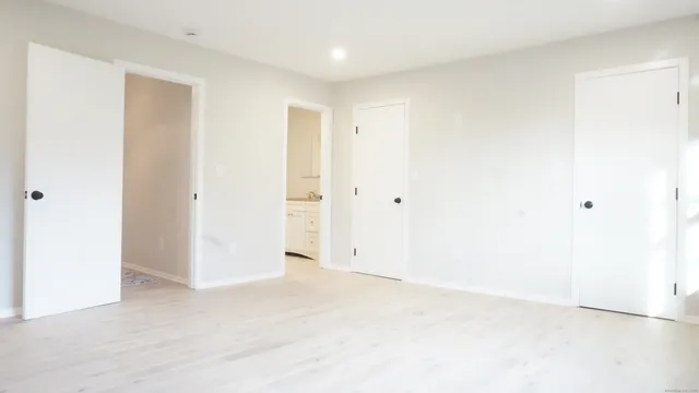 an empty room with closet and a bathroom