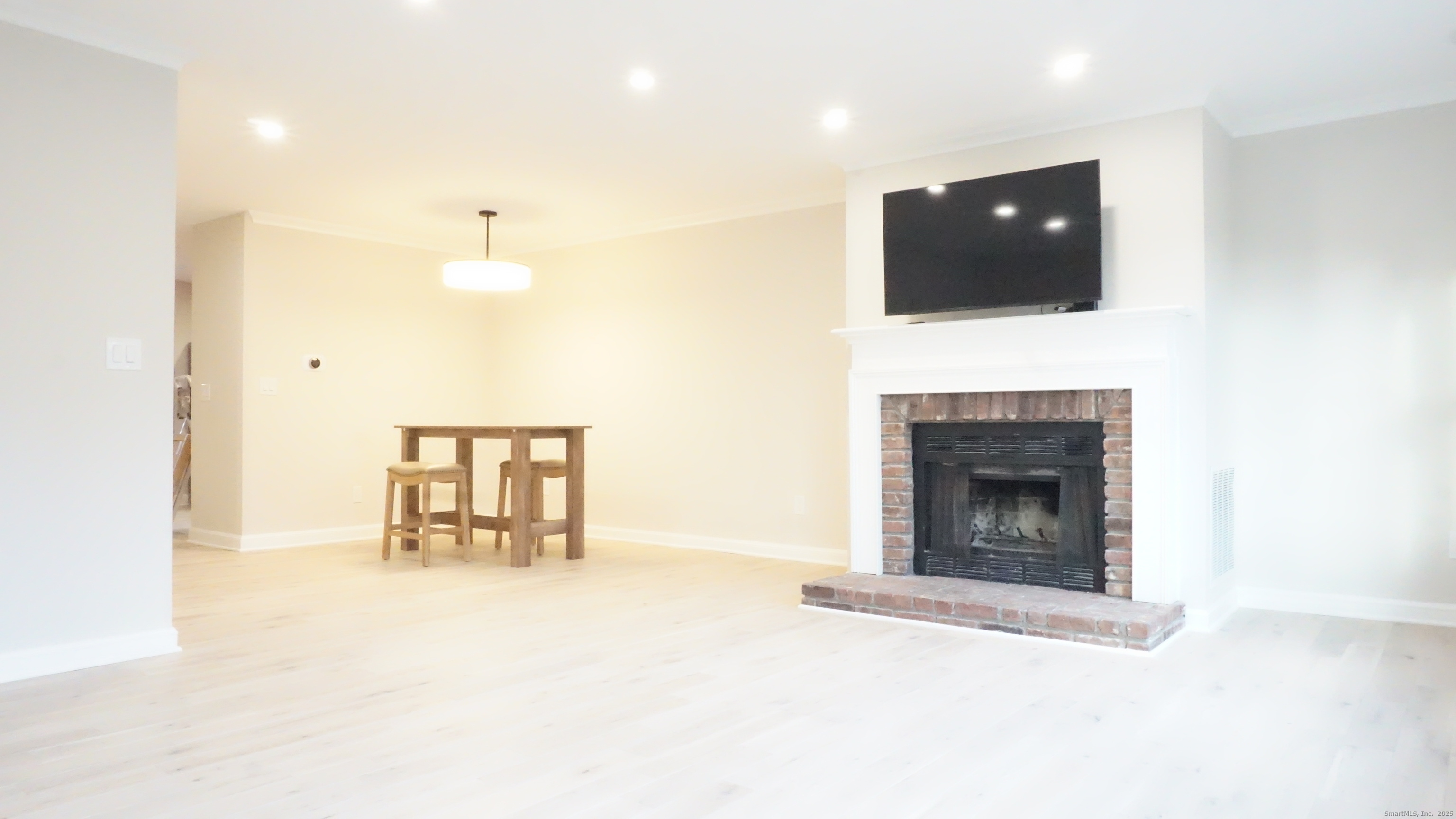 24 Overlook Drive, Unit 24 Monroe, CT 06468 - Photo 3 of 32 a view of an empty room with a fireplace and a window