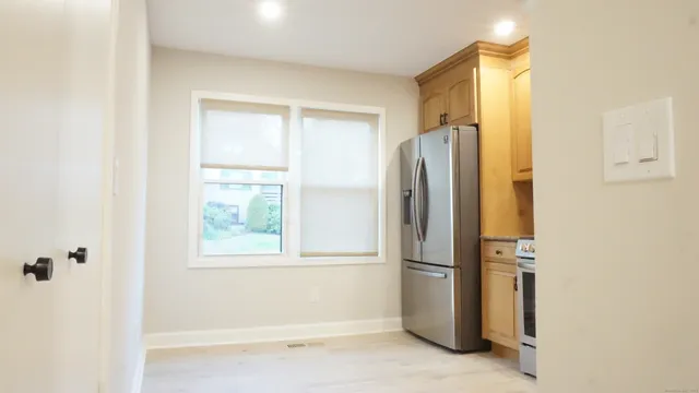 a white refrigerator freezer and a stove sitting inside of a kitchen