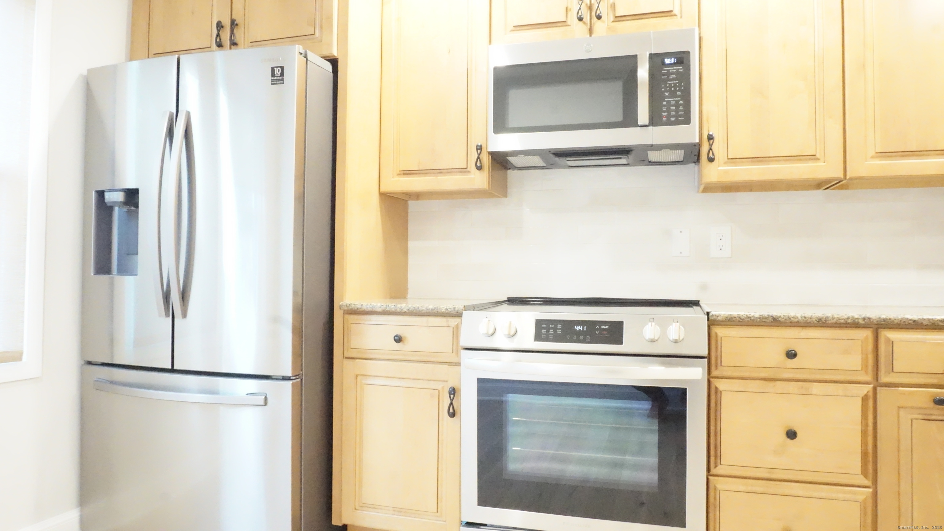 24 Overlook Drive, Unit 24 Monroe, CT 06468 - Photo 6 of 32 a white refrigerator freezer and a stove sitting inside of a kitchen