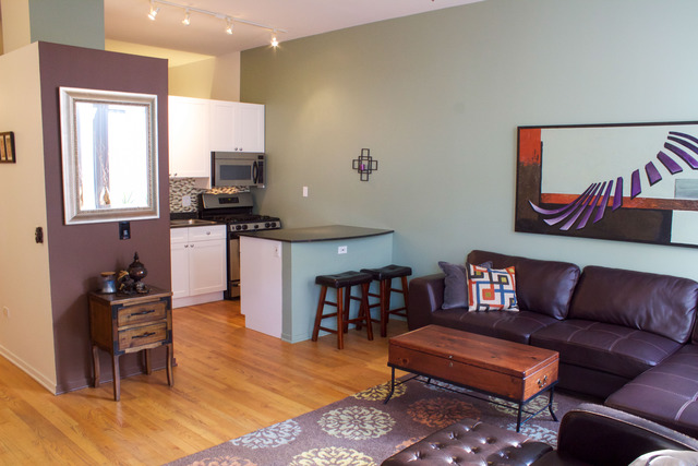 1201 West Adams Street, Unit 709 Chicago, IL 60607 - Photo 4 of 16 a living room with furniture and a wooden floor