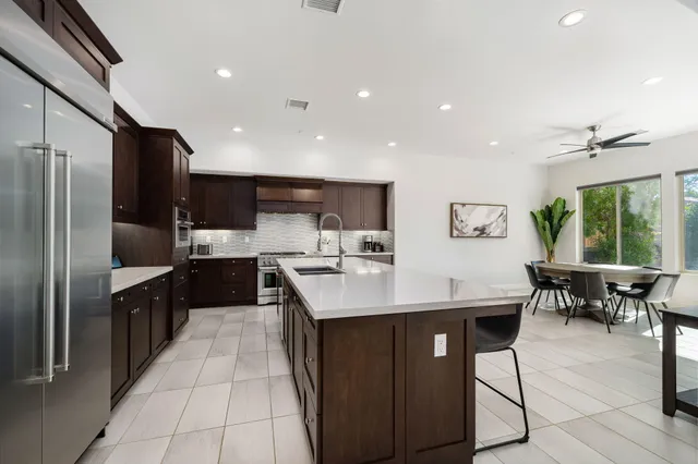 a spacious bedroom with a bed and a flat screen tv