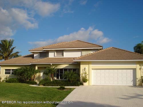 10 Inlet Cay Drive Ocean Ridge, FL 33435 - Photo 1 of 9 a front view of a house with a yard