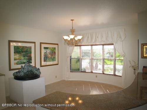 10 Inlet Cay Drive Ocean Ridge, FL 33435 - Photo 5 of 9 a kitchen with a window a chandelier and living room