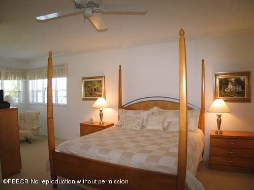10 Inlet Cay Drive Ocean Ridge, FL 33435 - Photo 8 of 9 a bedroom with a bed and a night stand