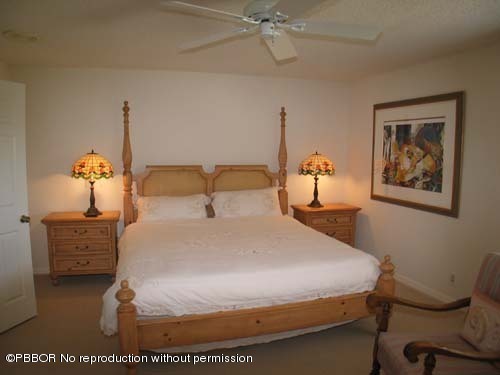 10 Inlet Cay Drive Ocean Ridge, FL 33435 - Photo 9 of 9 a bedroom with a bed and a chandelier