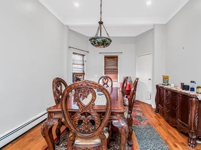a dining room with furniture a rug and wooden floor