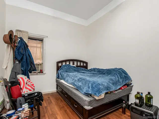 a bedroom with bed and a window