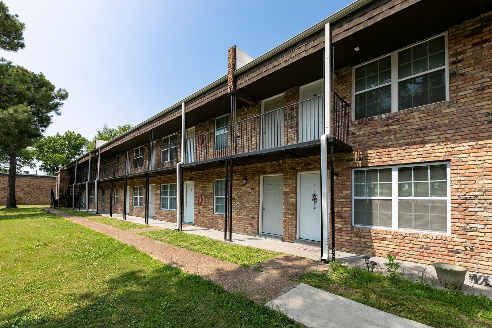 3236 Millington Road Memphis, TN 38127 - Photo 3 of 31 Brick exterior featuring a multi-story building with multiple entry doors and windows