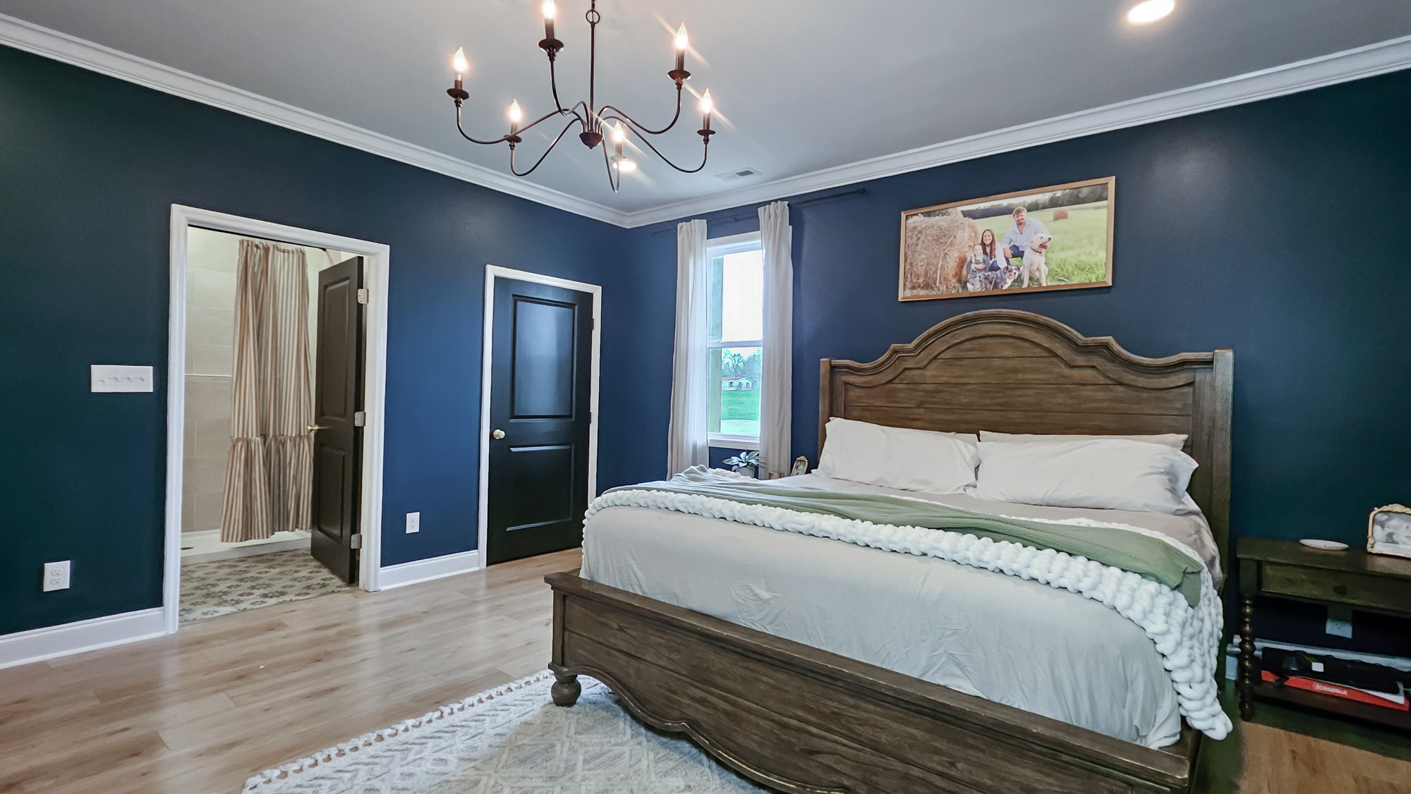 25872 Union Hill Road Ardmore, TN 38449 - Photo 16 of 28 a bedroom with a large bed and a chandelier