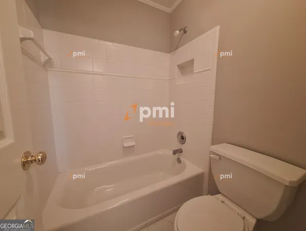 a bathroom with a toilet and a bathtub
